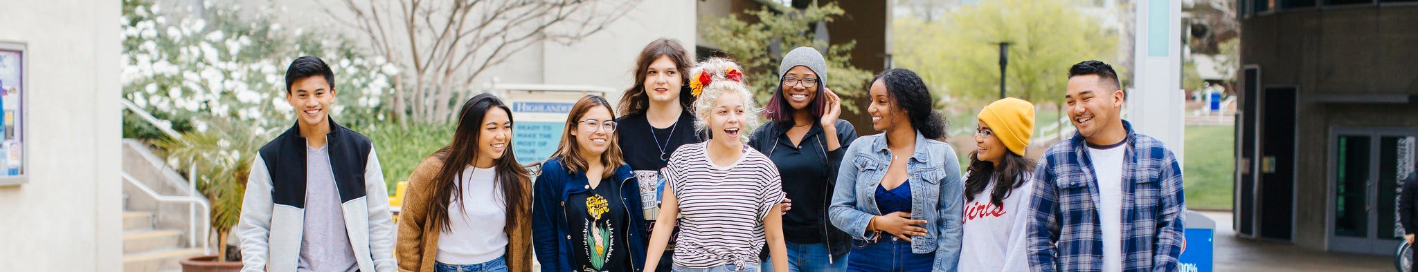 UCR students of various ethnicities, genders and backgrounds walk together across the UCR campus.