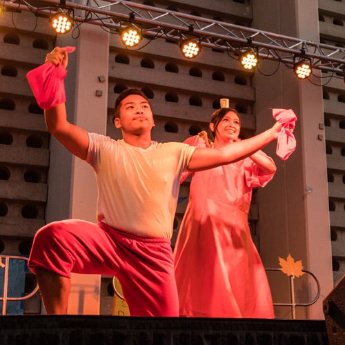 Students from Asian Pacific Students Programs perform a traditional dance at an event.