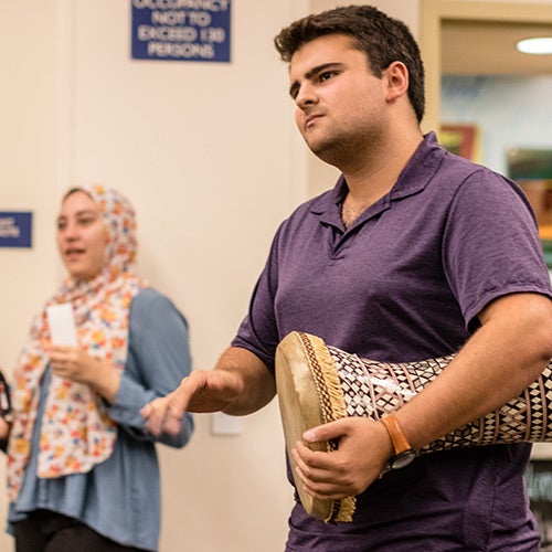 A member of the Middle Easter Student Center plays a drum called a doumbek.